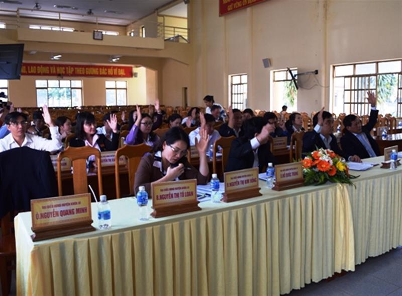 Các đại biểu HĐND huyện biểu quyết thông qua các tờ trình tại kỳ họp